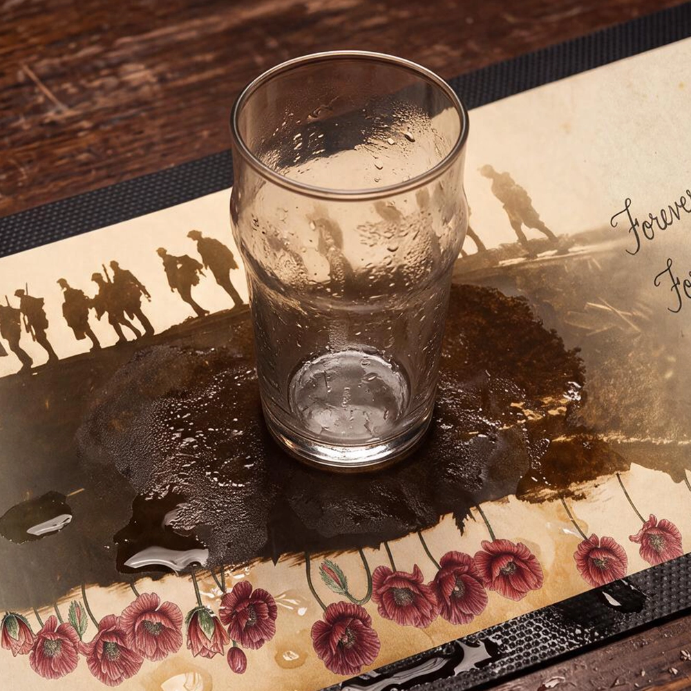 An empty glass sitting on the Forever Remembrance Bar Runner on a bar