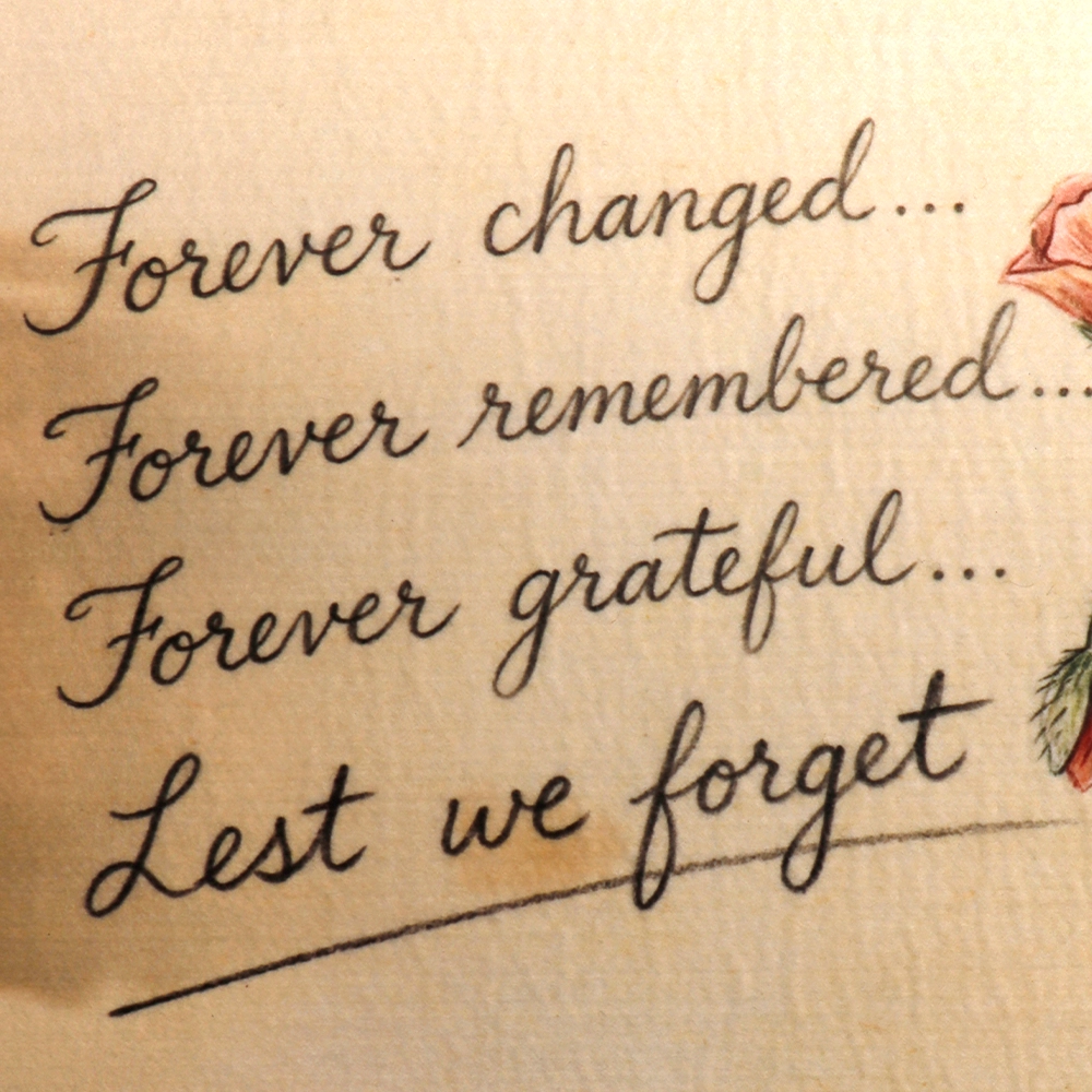 Close up image of Forever Changed... Forever Remembered... Forever Grateful... Lest We Forget on bar runner